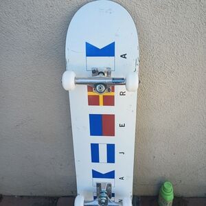 White Skateboard with Blue and Red Graphics
